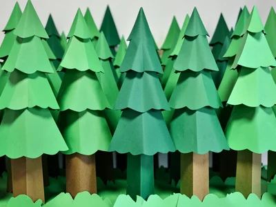 Forest of paper trees, each tree a different shade of green paper, layered depth