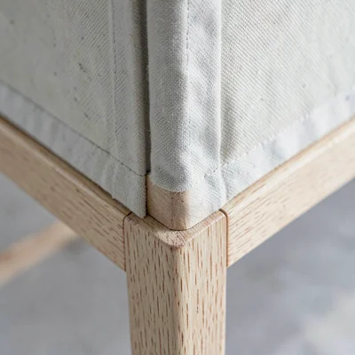 Macro study of a stretcher bar corner with mitered joinery and canvas tension