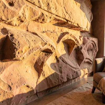 Warm desert-toned photograph, Carved rose sandstone wall detail catching golden 