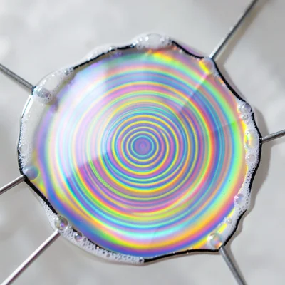 Soap film membrane vibrating at resonance frequency, standing wave pattern visib