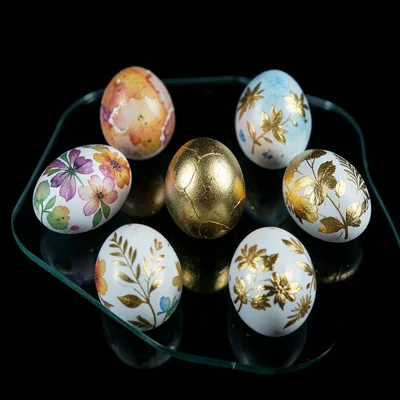 A collection of hand-painted Easter eggs arranged on the scanner glass — each a 