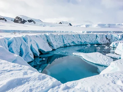 Surface pool draining through blue ice