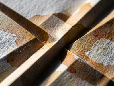 Accordion pleat in watercolor paper, cold-press texture amplified by raking ligh
