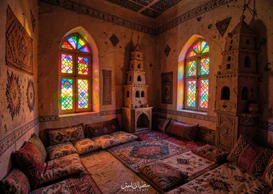 Colored light through qamariya windows in Sana'a, Yemen, traditional room with c