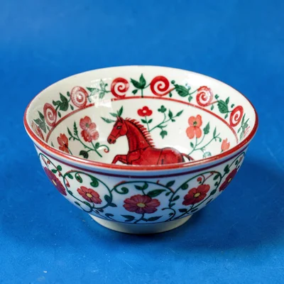 Rosemaling bowl — inside surface with C-scroll and flower motif in red and green