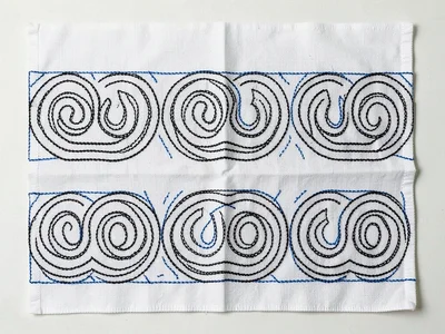 Textile panel showing protective band pattern — repeating curved forms in black 