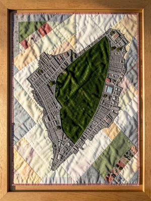 Manhattan island densely cross-stitched in grey with Central Park as a green vel
