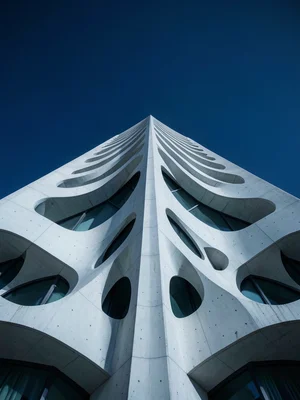 Parametric architecture facade with flowing organic curves, white concrete again