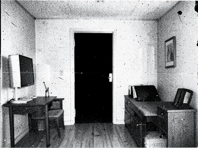Interior of a room degraded through copies, doorway a pure black rectangle, furn