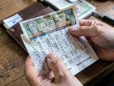 Lottery ticket receipt clutched tightly, the hope in thermal paper, checking num