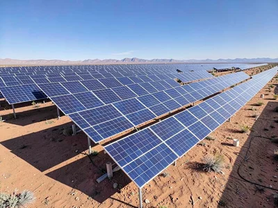 A solar farm in the Mojave, thousands of panels tilted at identical angles