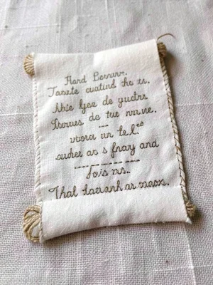 Hand-stitched diploma scroll on linen, Latin text in tiny chain stitch