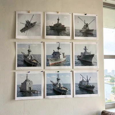 Shot-grid printout of nine 3D-shot breakdown frames pinned to a studio wall, sof