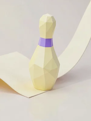 Pin-shaped butter-yellow lowpoly bowling pin with chunky lavender stripe facets