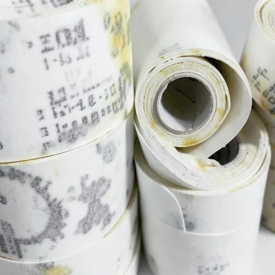 Stack of receipt paper rolls, end-on view showing tight spiral cross-sections of