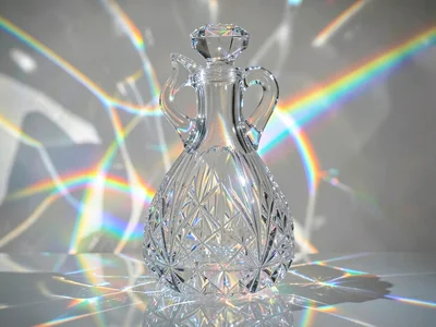 Cut glass decanter creating complex rainbow pattern