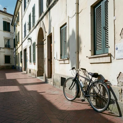 Siesta stillness, afternoon heat weight, A bicycle leaning against a wall, owner