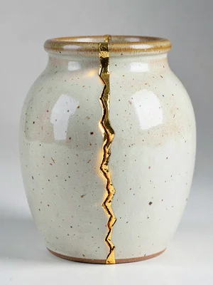 Ceramic jar with major crack running vertically — gold seam bridging the fractur