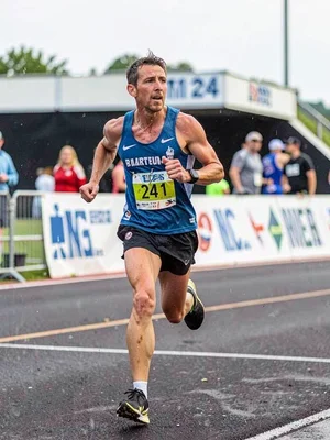 Marathon runner at mile 24, the determination blurred but the effort clear