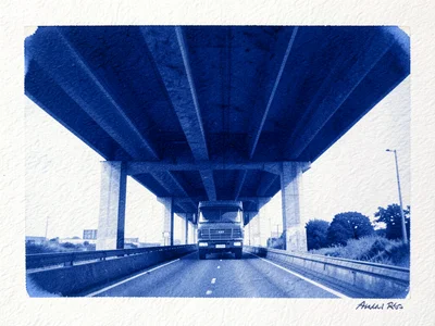 A highway overpass with a truck crossing, seen from below showing the underside 