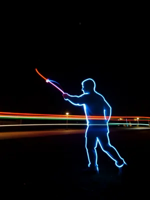 Person drawing their own silhouette with a light wand, long exposure, ghost outl