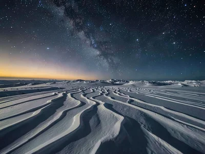 Wind-carved snow patterns under space-dark sky at 5000m