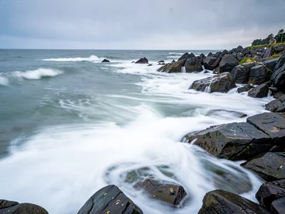 Rocky coastline with milk-white water flowing around