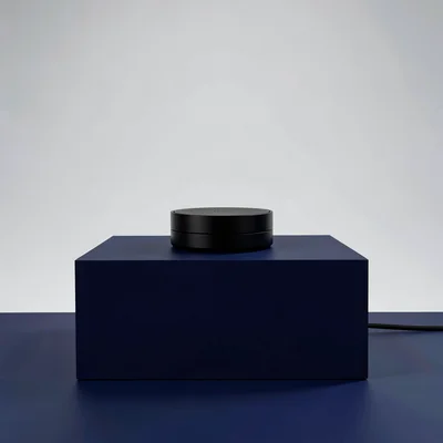 Color-block hero of a charging pedestal silhouette on a deep navy block, balance