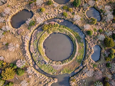 Water level variations creating concentric patterns around pools