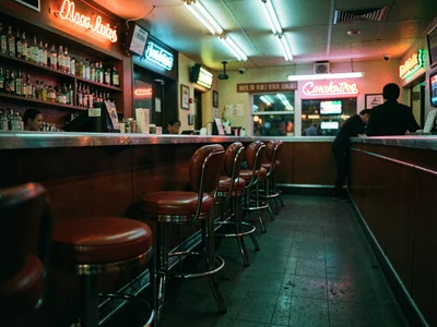 Empty chrome diner stools with red vinyl seats