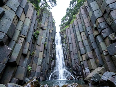 Waterfall framed by basalt column walls
