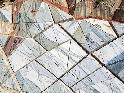 Crack patterns in quarry face creating abstract geometry