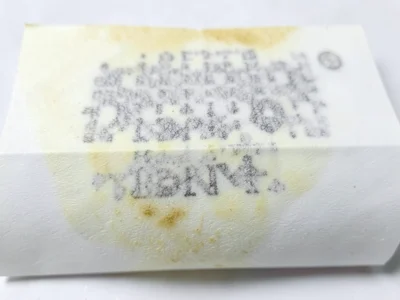 Receipt paper yellowed with age, thermal print completely vanished leaving only 