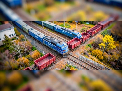 Locomotive tilt-shift photograph from a high embankment over a marshalling compl