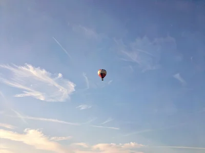 Hot air balloon tiny in sky