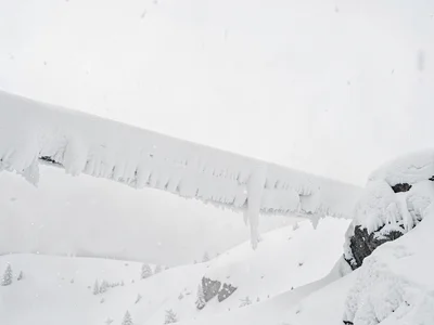 Snow cornice overhang against white sky