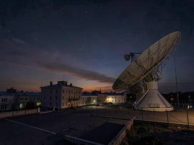 Radio dish array pointing at darkening eastern sky