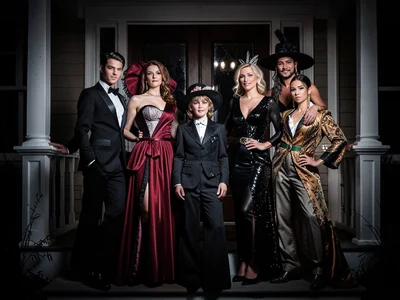 Family in matching themed costumes posing on front porch, group effort