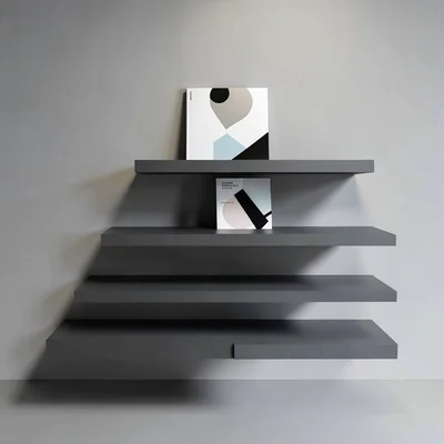 Tiered shelf display of three abstract exhibition catalogues stepping back into 