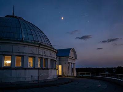 Dome slit aligned with visible planet at twilight