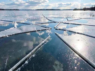 Open water reflecting sky between ice