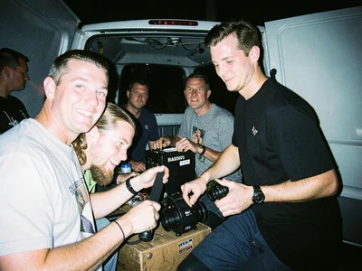 Band loading gear into a van at 2am