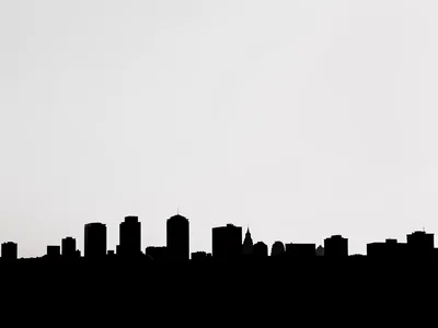 City skyline solarized at the horizon line, buildings become negative space and 