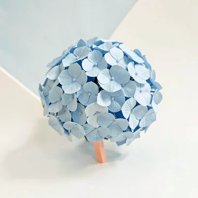 Globular sky-blue lowpoly hydrangea ball of triangulated florets and a peach ste