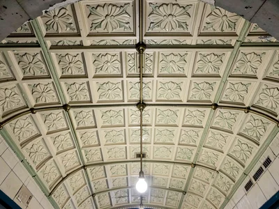 The ceiling of an Art Nouveau Budapest metro station, ornate pressed tin panels 
