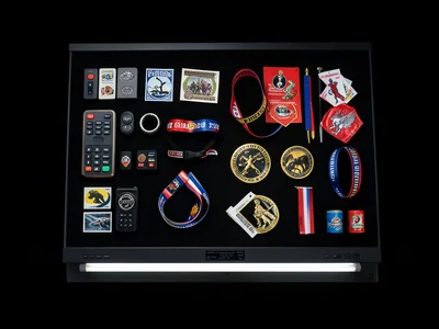 Scanner capture of pride memorabilia, buttons, stickers, wristbands, flags