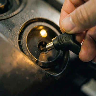 Tight crop of a connector clicking into a vehicle port with a subtle indicator g