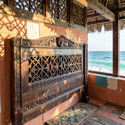 Coastal architecture photograph with Swahili influences, Carved wooden headboard