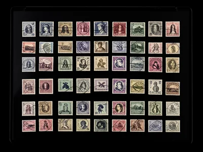 Vintage postage stamps arranged in tight grid on scanner, cancelled stamps with 