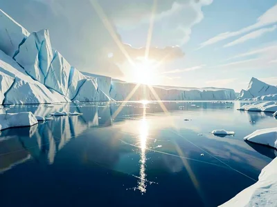 Dramatic pale sun flares low over a meltwater lake, sending elongated shimmer ac